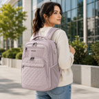 Pink quilted laptop backpack with front zip pockets and padded straps