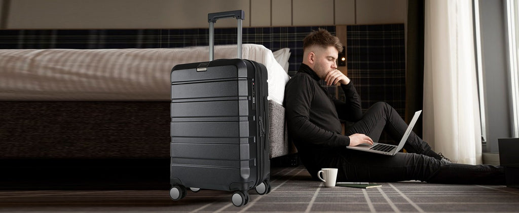 Black hardside carry-on luggage with telescoping handle and spinner wheels