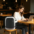 Black and white laptop backpack with side handle and shoulder straps, shown on a table