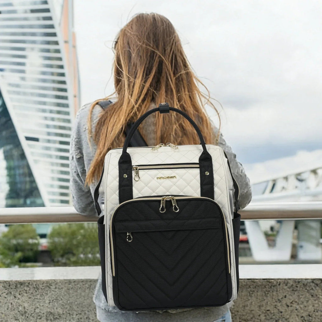 Black and ivory quilted laptop backpack worn with rear view and adjustable shoulder straps